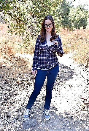 Geeky brunette in a checkered shirt shows her big naturals outdoors